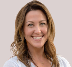 Headshot of woman with light brown curled hair
