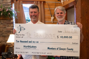 two men holding check