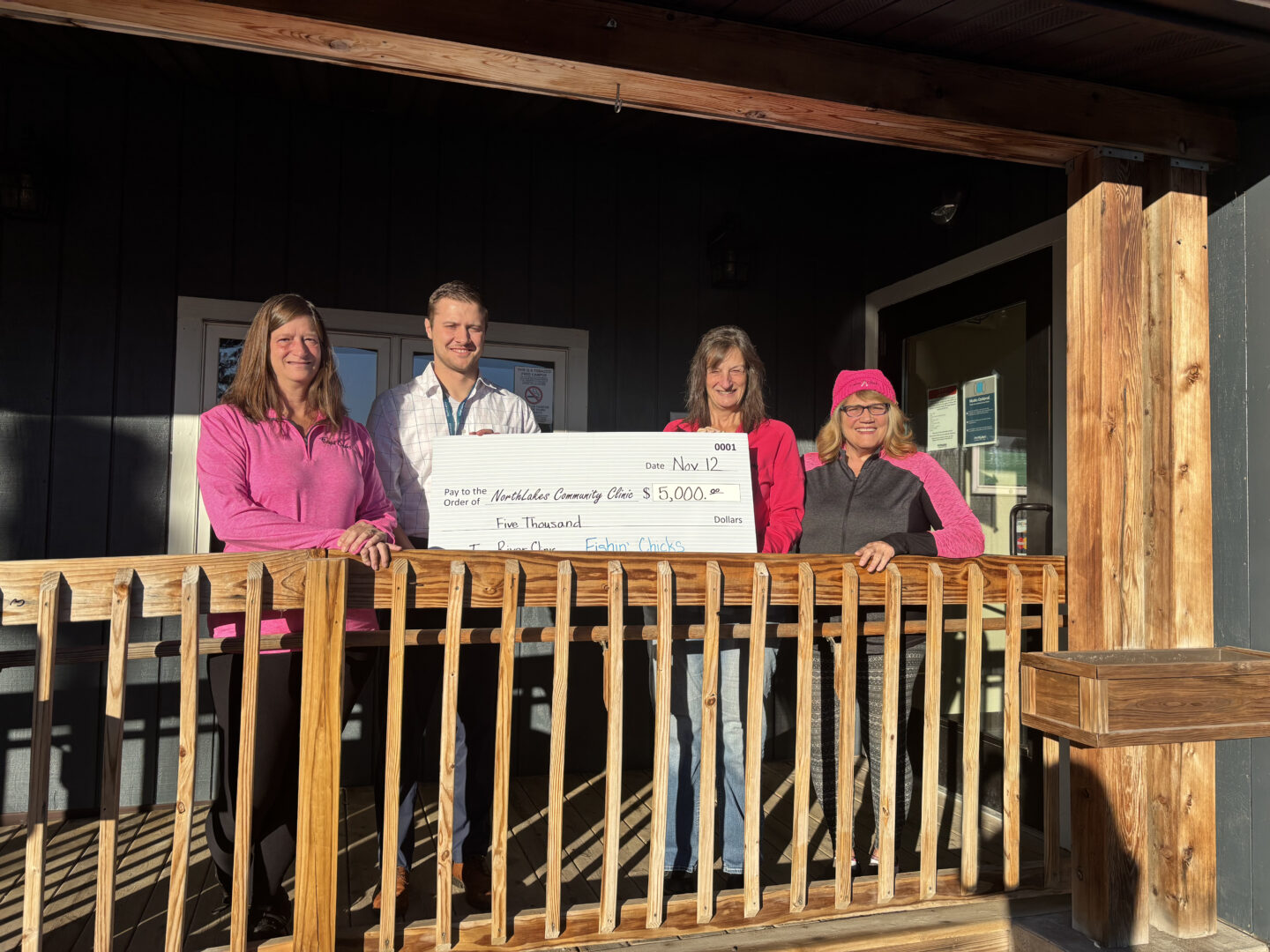group holding check on front porch