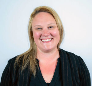 Woman with blond hair and black blouse, smiling