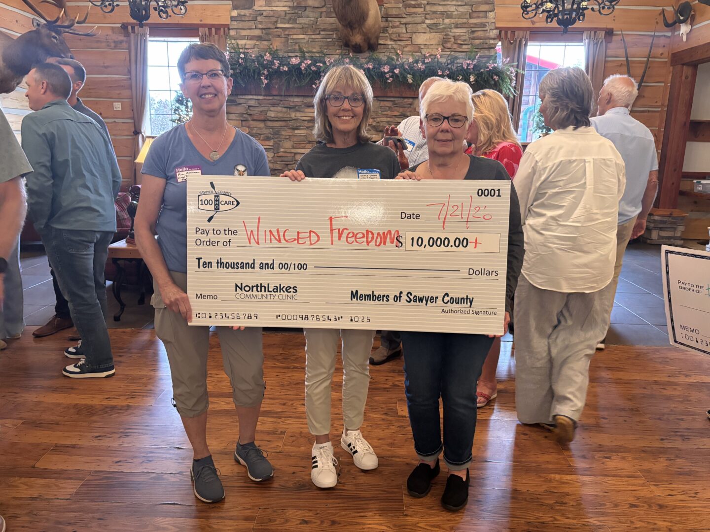 Three women holding a check.